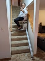 Woman-giving-thumbs-up-on-new-stairlift-in-Wichita-home.jpg