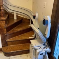 curved-stairlift-at-bottom-landing-of-stairs-in-Darien-IL-home-by-Lifeway-Mobility.JPG