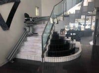 curved stairlift with custom black upholstery and gray rail in San Francisco bay home