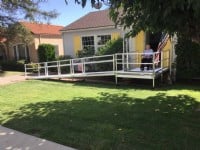 man in wheelchair see his new aluminum wheelchair ramp in front of long beach CA home