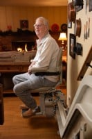 man sitting and smiling on stairlift in Elk Grove home