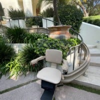 outdoor curved stairlift atbottom landing in Beverly Hills from Lifeway Mobility