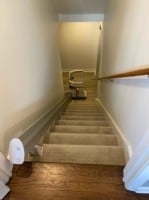 stairlift at bottom landing of stairs in home in Carmel Indiana installed by Lifeway Mobility