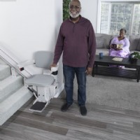 man standing beside Bruno Elite curved stairlift
