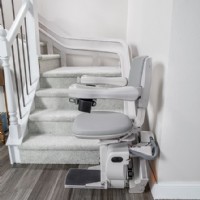 Bruno Elite curved stairlift at bottom landing side view installed by Lifeway Mobility
