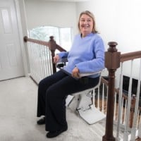 Lifeway Mobility Bruno Elan top of steps woman turned on seat smiling