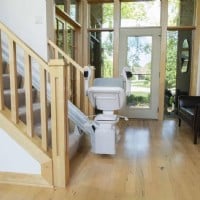 Bruno Elite stairlift with new seat folded up at bottom landing of stairs