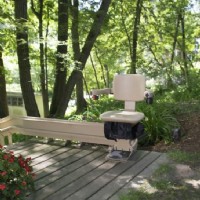 Bruno outdoor Elite curved stairlift at top landing of staircase