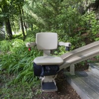 Bruno outdoor curved chair at bottom landing of stairs from Lifeway Mobility