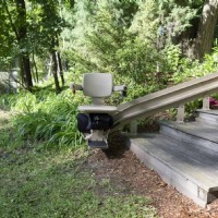 Bruno outdoor curved stairlift from Lifeway Mobility at bottom of staircase