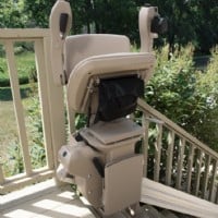 Bruno outdoor elite stairlift chair folded up at top of stairs installed by Lifeway Mobility