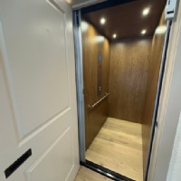 Garaventa home elevator with wood interior installed by Lifeway Mobility