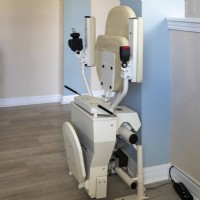 Harmar Helix curved stairlift from Lifeway Mobility with components folded at top landing