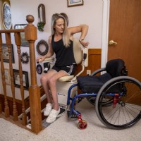 woman transfer from Harmar curved stairlift from Lifeway Mobility to her wheelchair