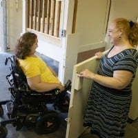 mom opens Highlander VPL door for daughter in power chair to safely enter home through garage