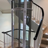 vacuum style elevator built around staircase by Lifeway Mobility Denver