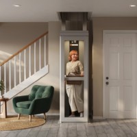 woman holding laundry basket in Lifeway Mobility Pollock home elevator