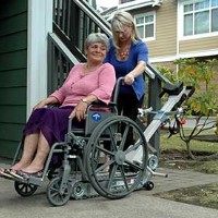woman transporting disabled mother in stair trac