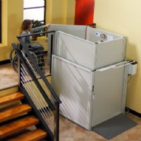 women entering Bruno 3gate commercial platform lift at top