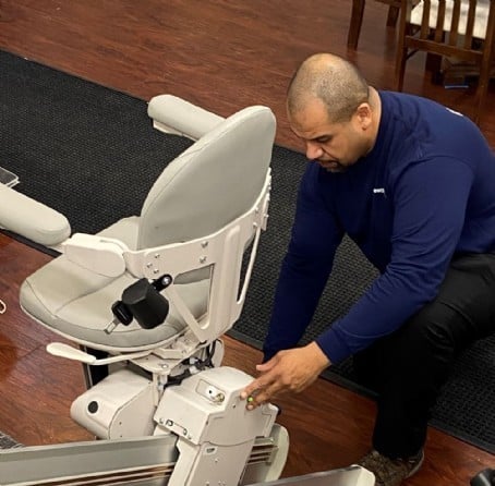 Lifeway technician servicing stairlift after installation in customers home