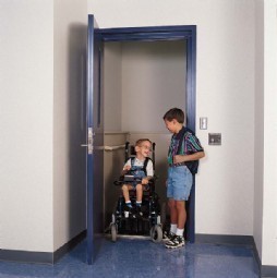 little boy in vertical platform lift in hoistway in school