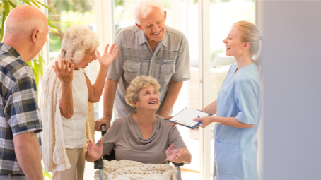 nurse meeting with senior couple and their friends