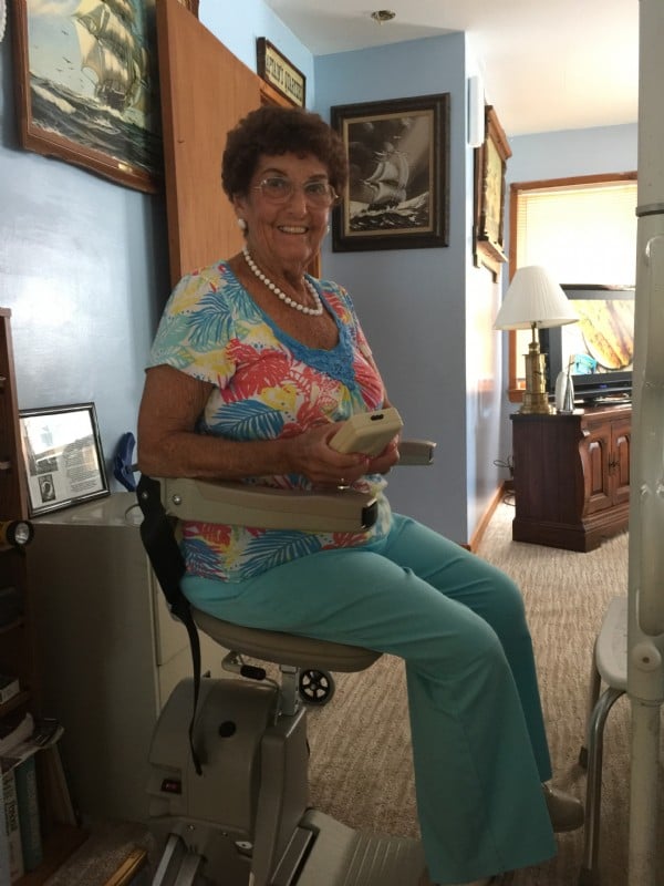 Woman-using-remote-control-to-operate-her-Bruno-Elan-stairlift