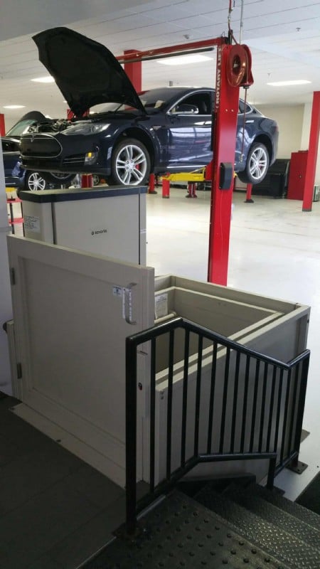 Commercial VPLs/commercial wheelchair lift in Tesla Motors service center with Tesla vehicle in background