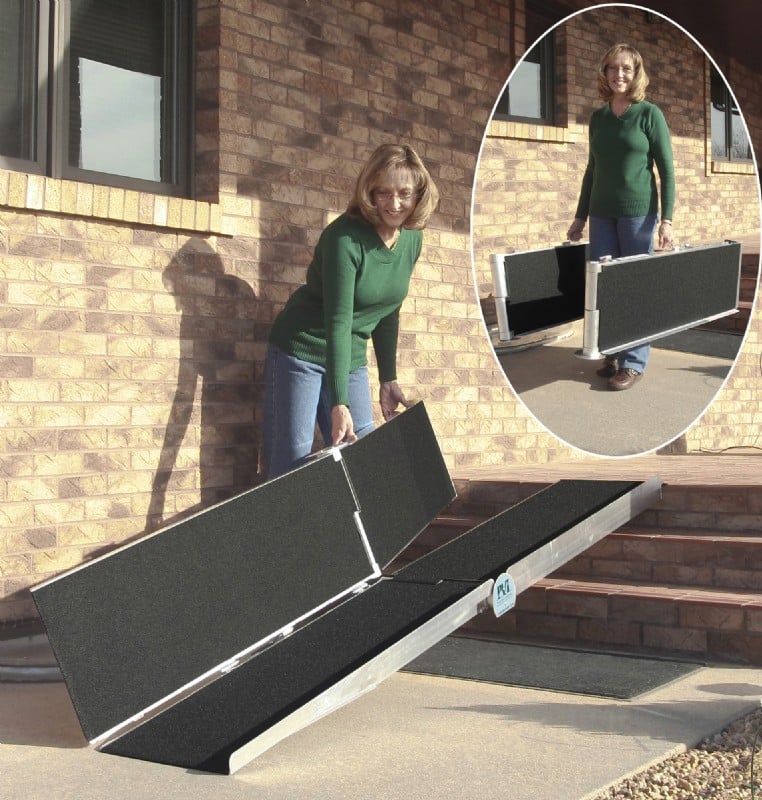 Woman folding and carrying the Suitcase Trifold AS Ramp