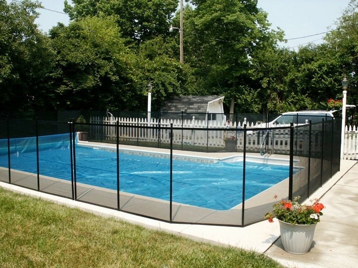 Protect A Child mesh pool fence around clear-covered pool