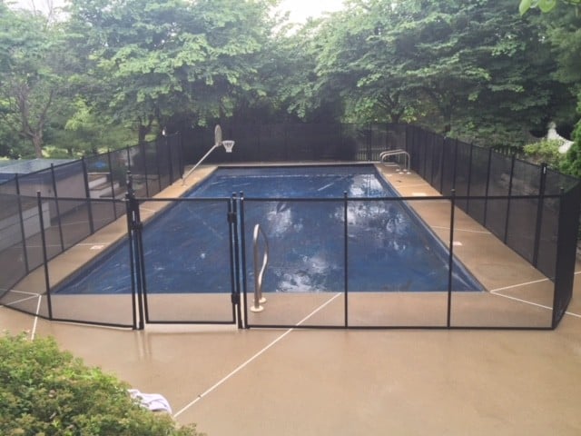 Protect A Child mesh pool fence around a shaded rectangular pool