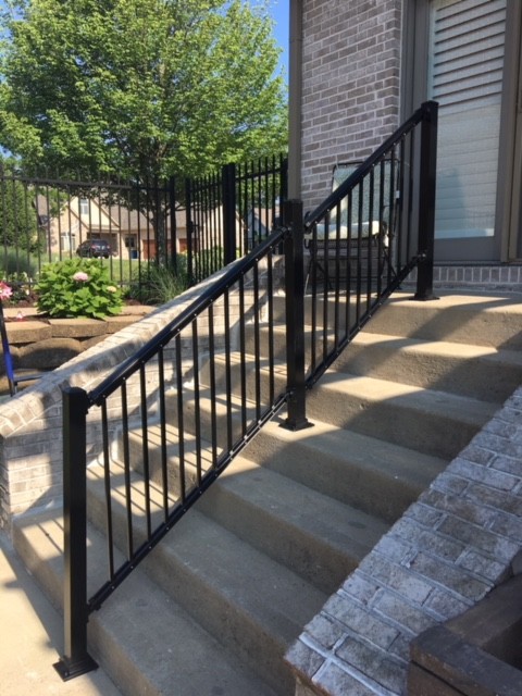 A Single Summit Black Aluminum Handrail on a Tall Set of Stairs