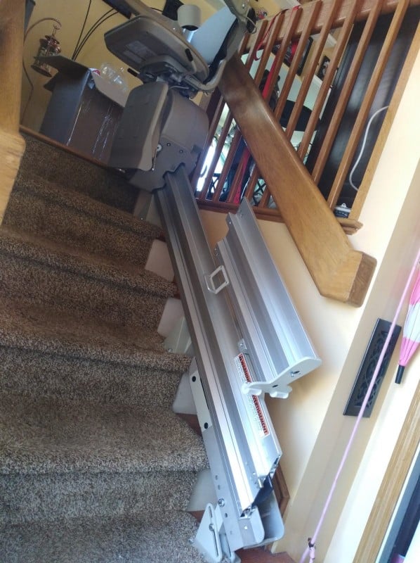 manual folding rail for stairlift flipped up to remove tripping hazard