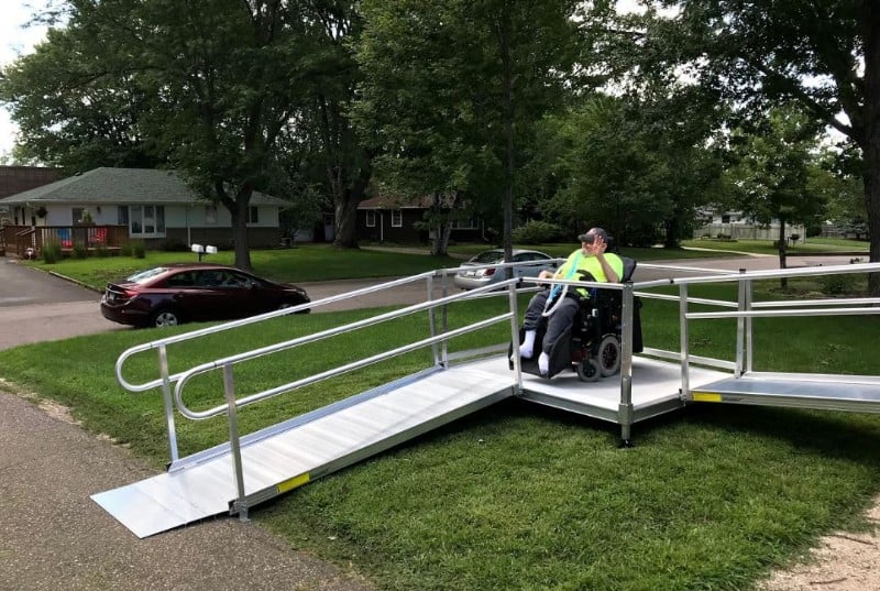 powerchair-user-takes-his-first-down-ride-his-new-aluminum-wheelchair-ramp.JPG