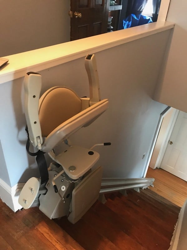 stair-lift-with-components-folded-up-at-top-landing-of-stairs-in-Havervill-Massachuetts.jpg