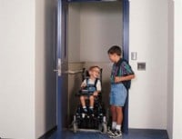 two-boys-getting-out-of-enclosed-commercial-wheelchair-lift-in-school