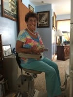 Woman-using-remote-control-to-operate-her-Bruno-Elan-stairlift
