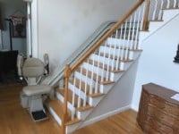 Bruno-curved-stairlift-at-bottom-landing-with-components-folded-up.jpg