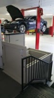 commercial-wheelchair-lift-in-Tesla-Motors-service-center-with-Tesla-vehicle-in-background.jpg