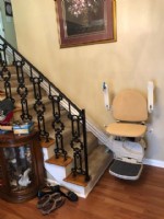 Handicare 950 stairlift at bottom landing with arms folded up
