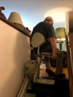 Lifeway Minnesota customer swiveling seat of stairlift at top landing