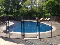 Pool fence built around residential pool in Indianapolis with a stone walkway