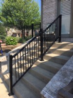 A Single Summit Black Aluminum Handrail on a Tall Set of Stairs