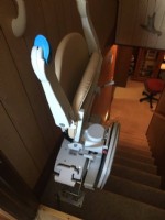 Stairlift at Top of Basement Stairs with arms seat and footrest folded up