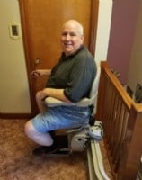 Veteran riding a Bruno Elite curved stair lift installed in Stickney, Illinois