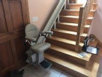 curved stairlift at bottom landing in home in Framingham Mass