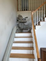 curved stairlift halfway up staircase in home in Massachusetts