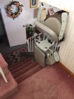 stairlift-at-top-landing-with-components-folded-up-at-home-in-Bedford-Mass.jpg