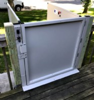 upper level landing gate of porch lift installed for deck access outside of home in Minnesota