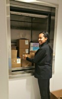 woman-unloading-boxes-out-of-dumbwaiter-in-Fannie-May-candy-store-in-Chicago.jpg